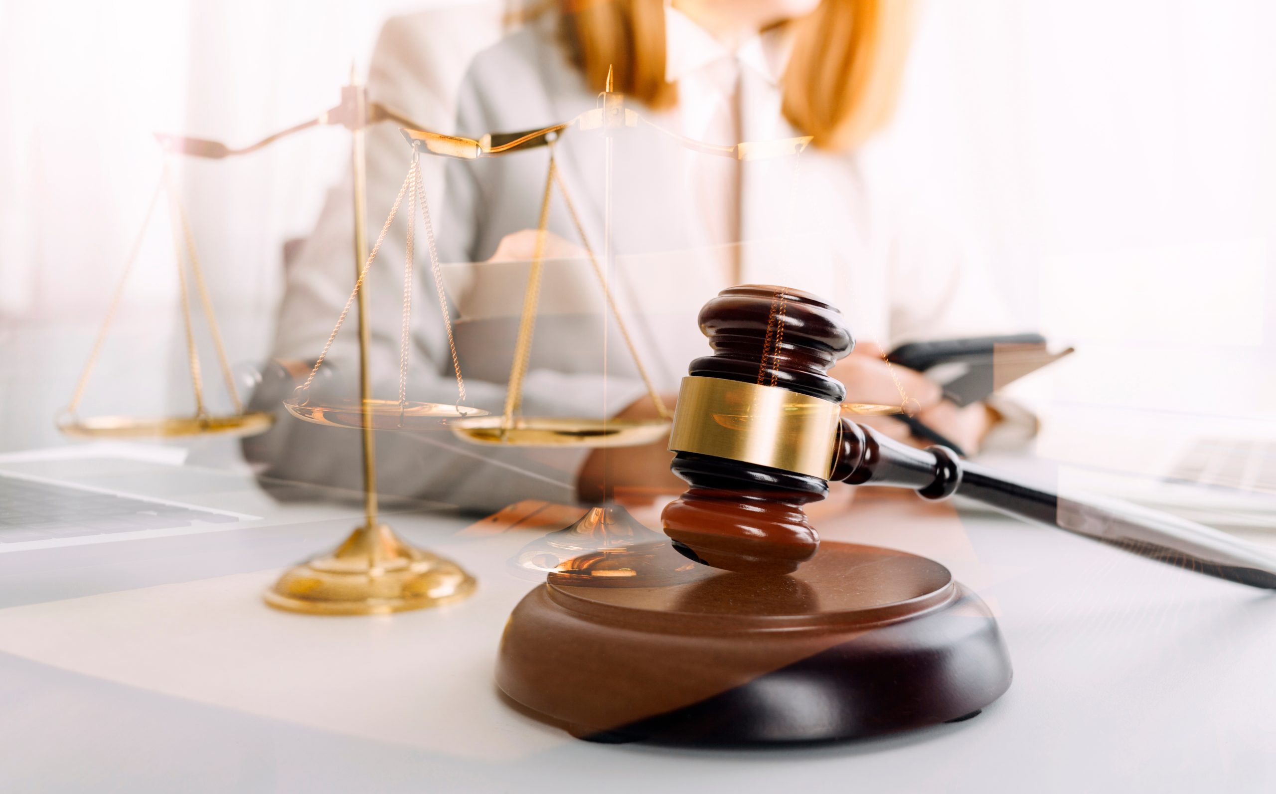 Business and lawyers discussing contract papers with brass scale on desk in office. Law, legal services, advice, justice and law concept picture with film grain effect
